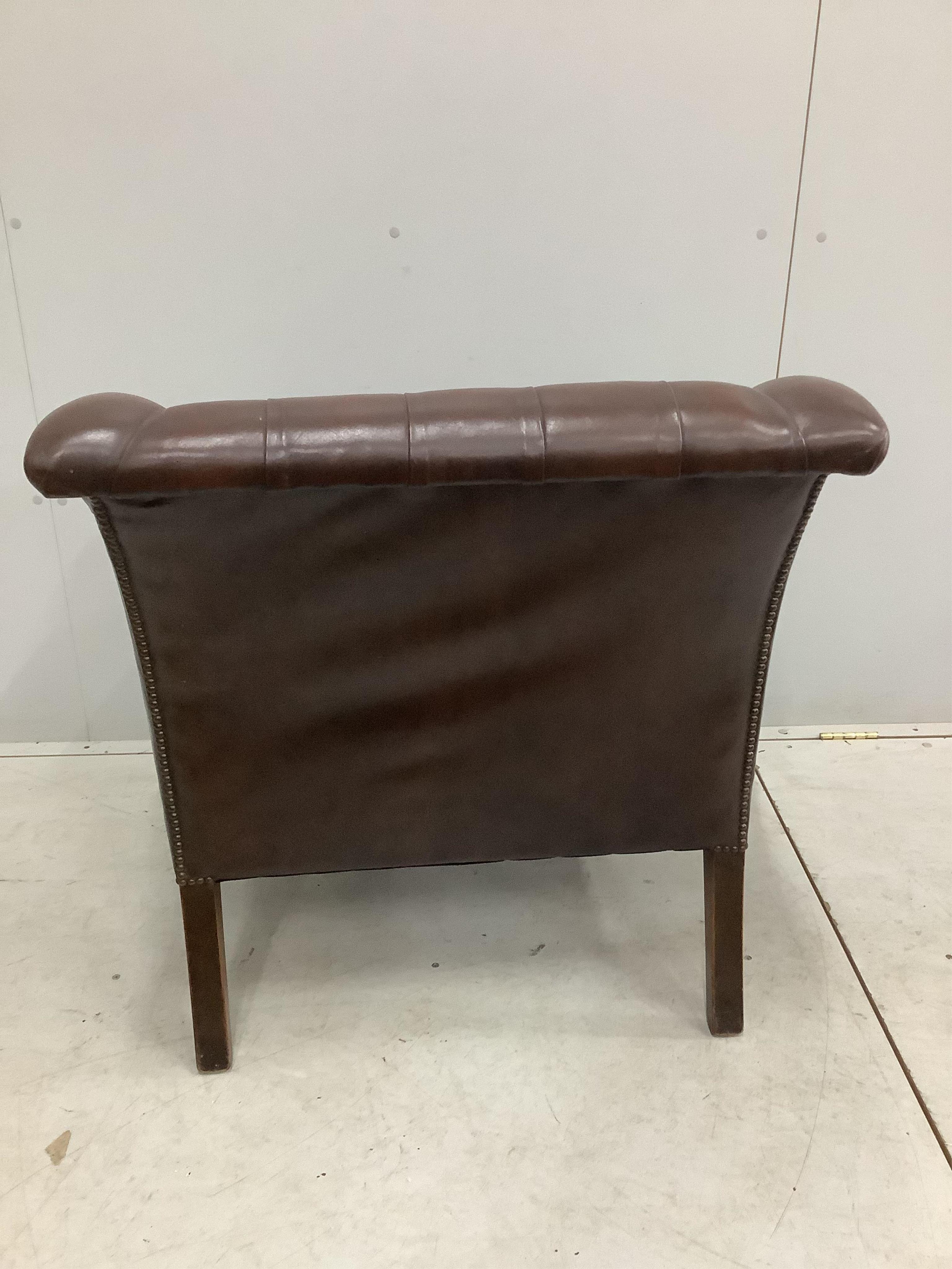 A George III style buttoned brown leather club chair, width 90cm, depth 76cm, height 82cm. Condition - fair